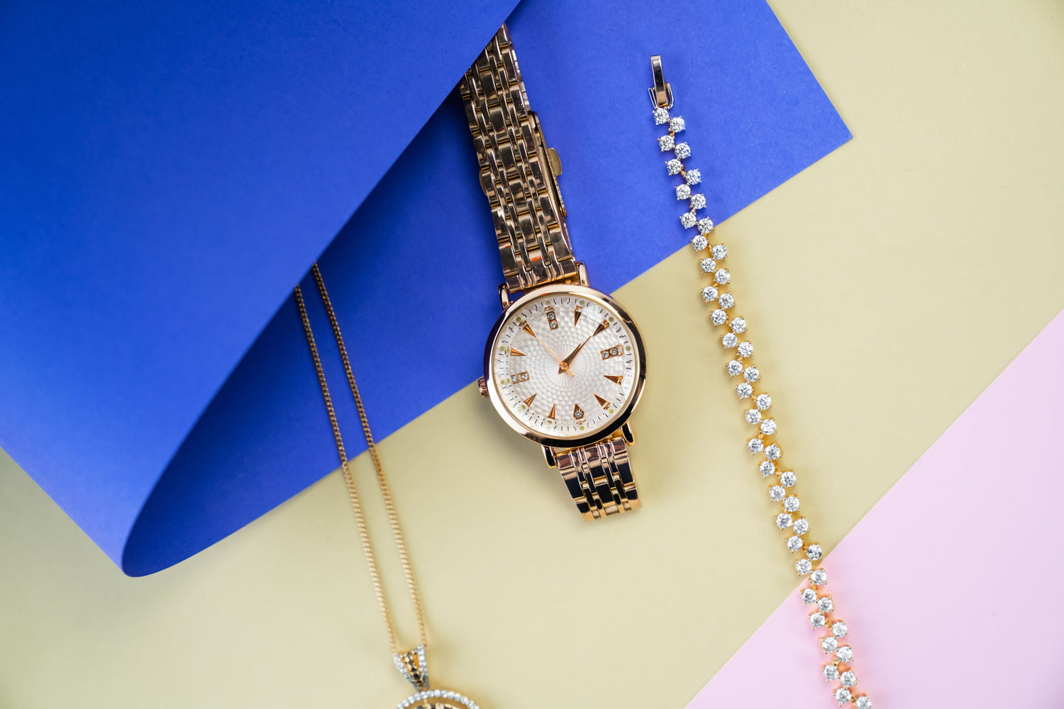 Luxury Jewelry and Gold Watch Composition on Colorful Background